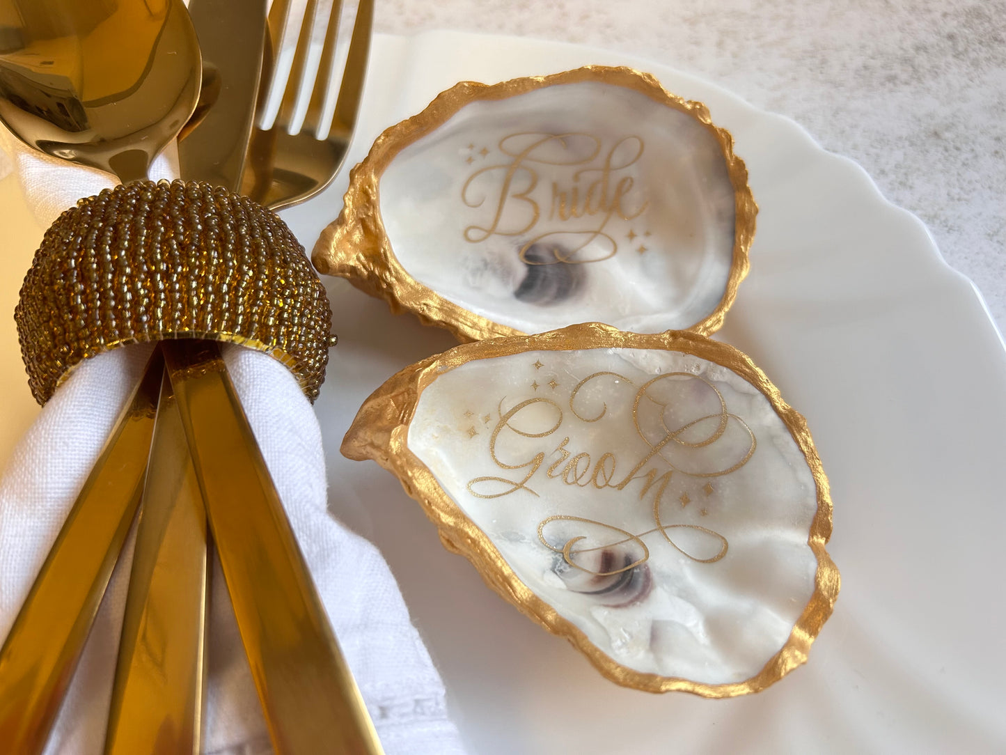 Gold Oyster Shell Wedding Favours And Place Cards.
