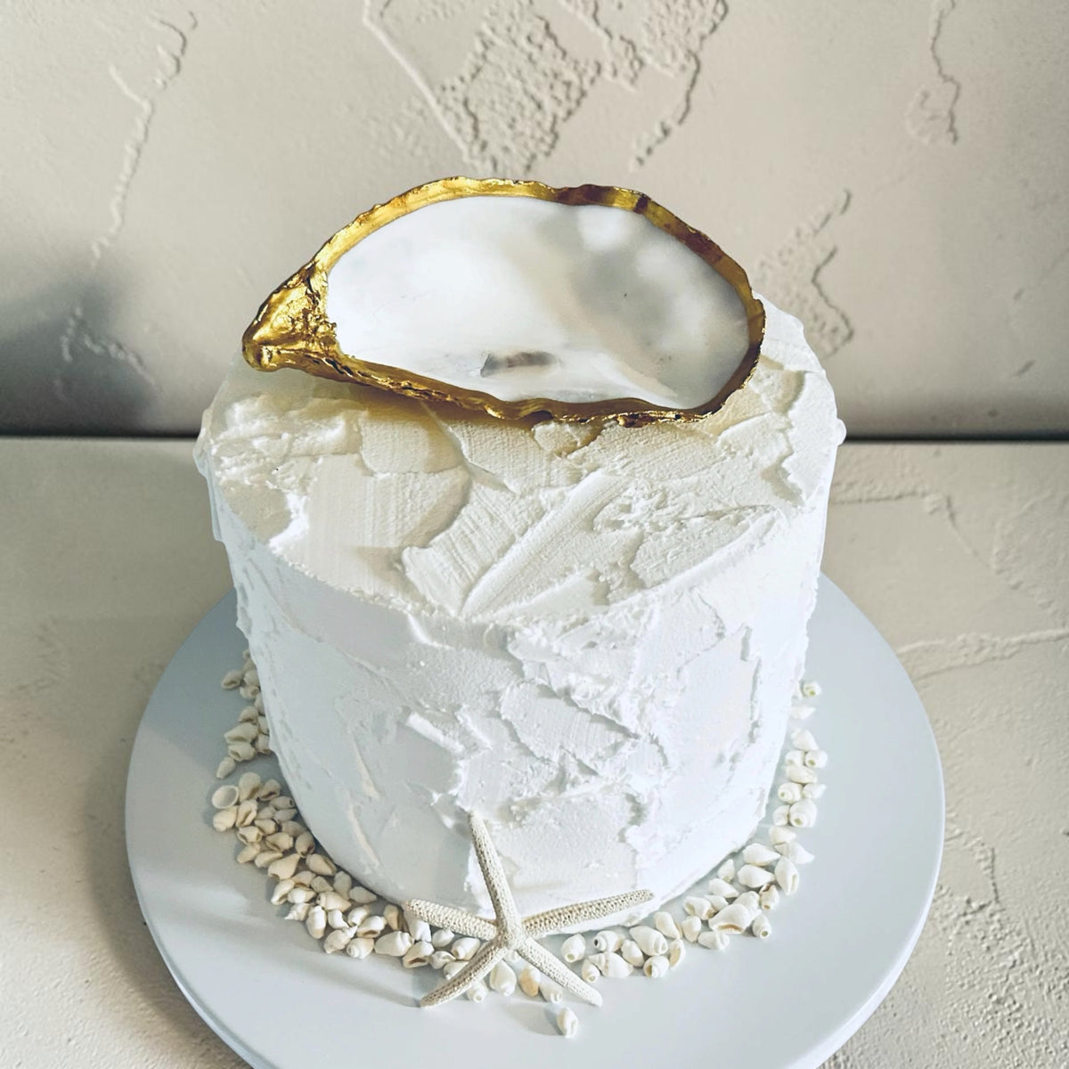 Personalised antique gold oyster shell wedding cake topper