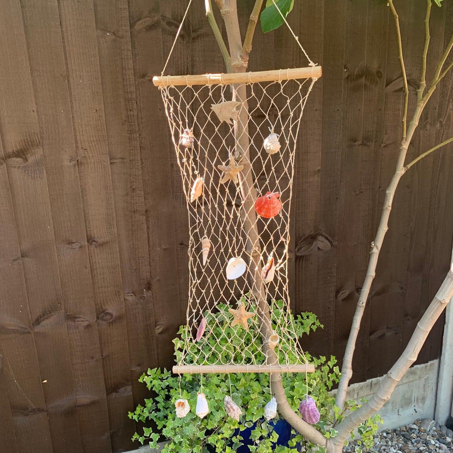 Fisherman net and sea shell nautical hanging decor. Natural wood, Shell and starfish mobile. Beach themed decoration for the garden or spa.