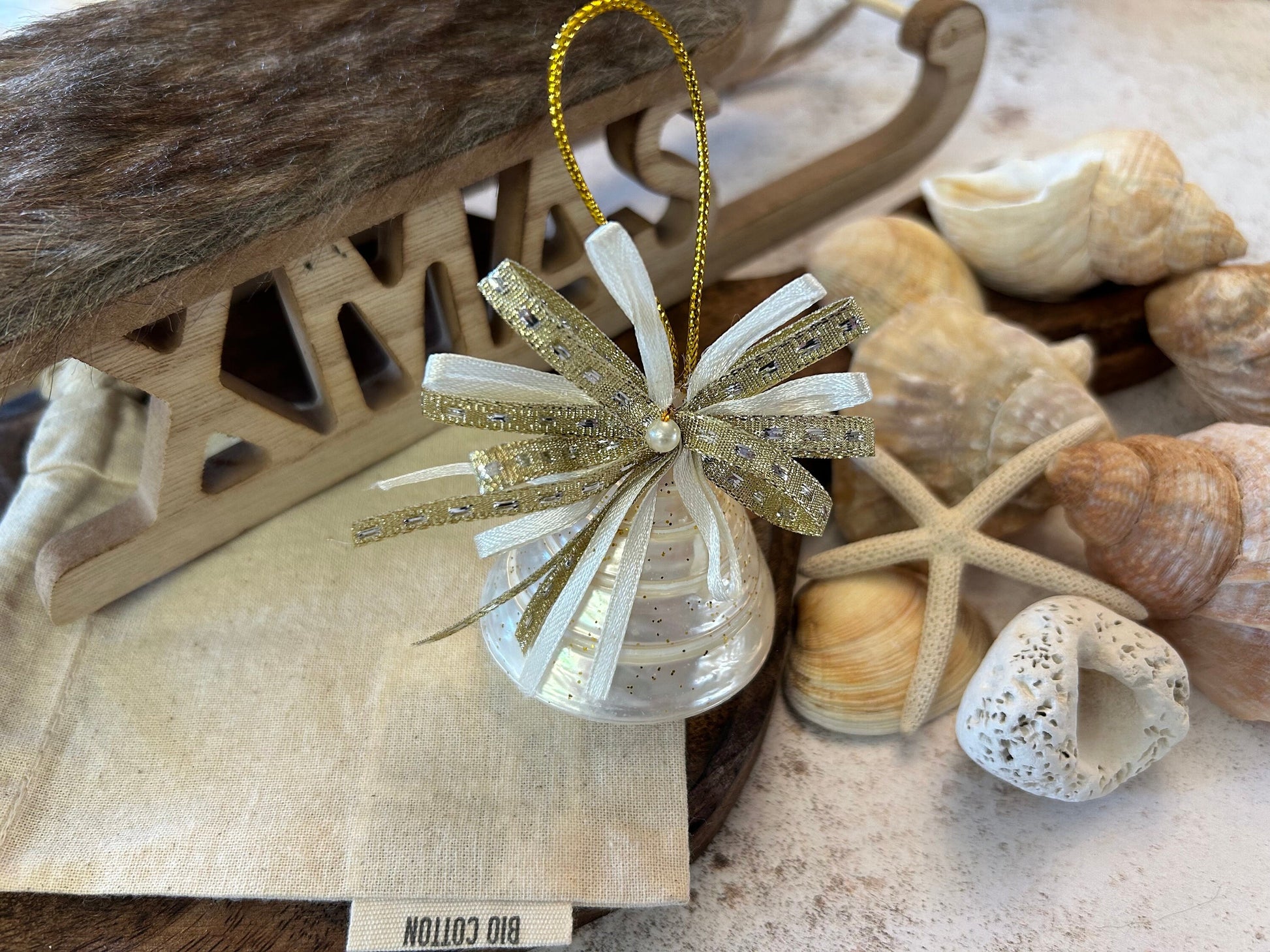 Pearlescent shell hanging decoration. Natural Trochus spiral shell bauble. Mother of Pearl and gold glitter door decor. Fisherman aesthetic