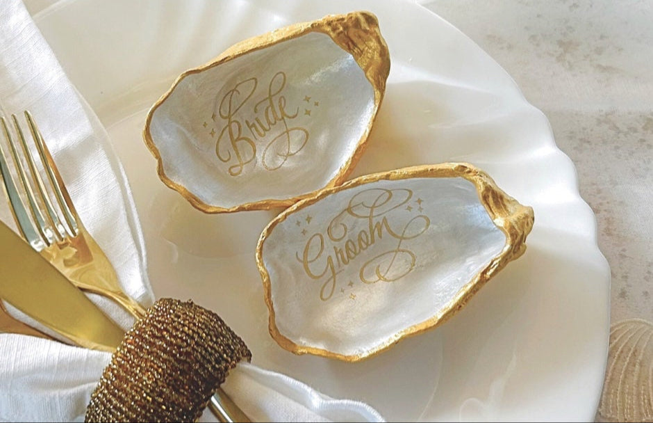 Natural oyster shells place names  and favours, finished in a luxurious gold and personalised for your wedding guests. These will add a touch of sophisticated luxury to your  wedding.  AAA Natural freshwater 7/8mm pearls are also optional.