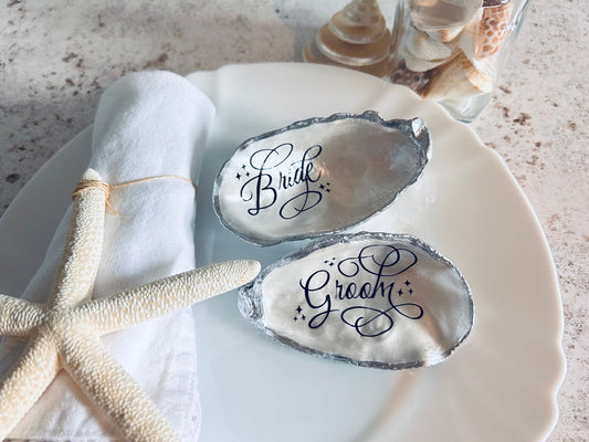 Oyster Shell Wedding Place Card and Favour. Personalised place names for your beach wedding decor. Silver coastal shell place settings.