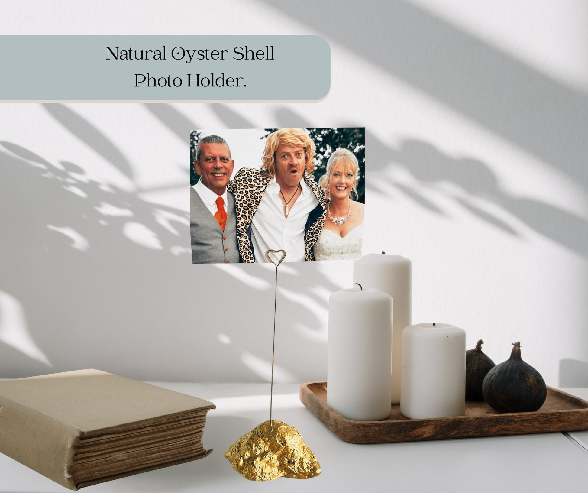 A natural oyster shell finished in gold with a gold metal heart clip to hold a photograph and will add a touch of sophisticated luxury to your home. Made by nature’s sea and up cycled sustainably. Each shell measures approx 3 to 4 by 2 to 4 inches.