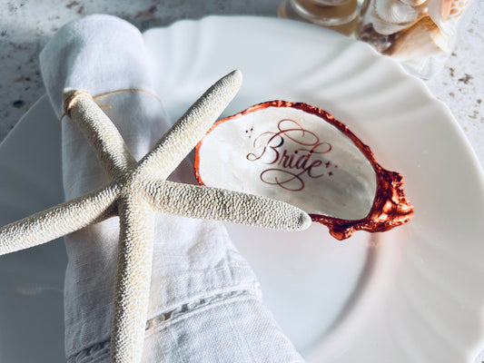 Copper oyster shell wedding favour and name place.
