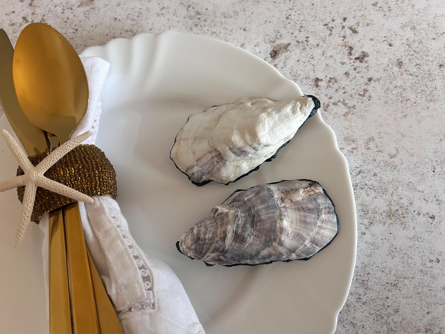 Natural oyster shells. These are the shell undersides which are white with light grey markings.