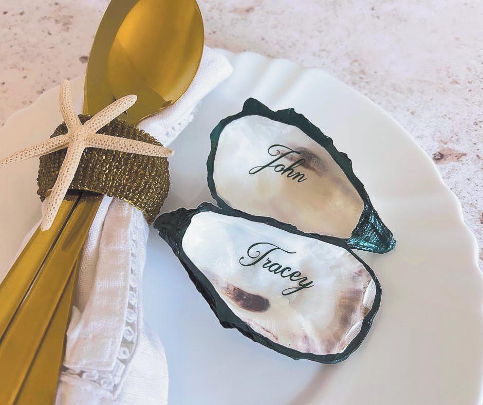 Emerald Green edged natural oyster shell place cards with emerald green calligraphy.