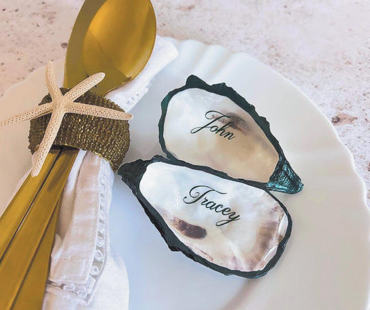 Emerald Green edged natural oyster shell place cards with emerald green calligraphy.
