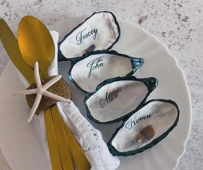 Natural oyster shells with dark green edges and calligraphy writing.