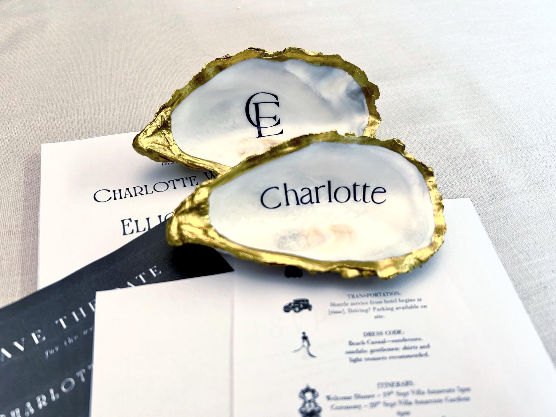 Antige gold edged natural oyster shells . natural inside and underneath. finish with personalisation in a elegant font with a name or monogram initials.