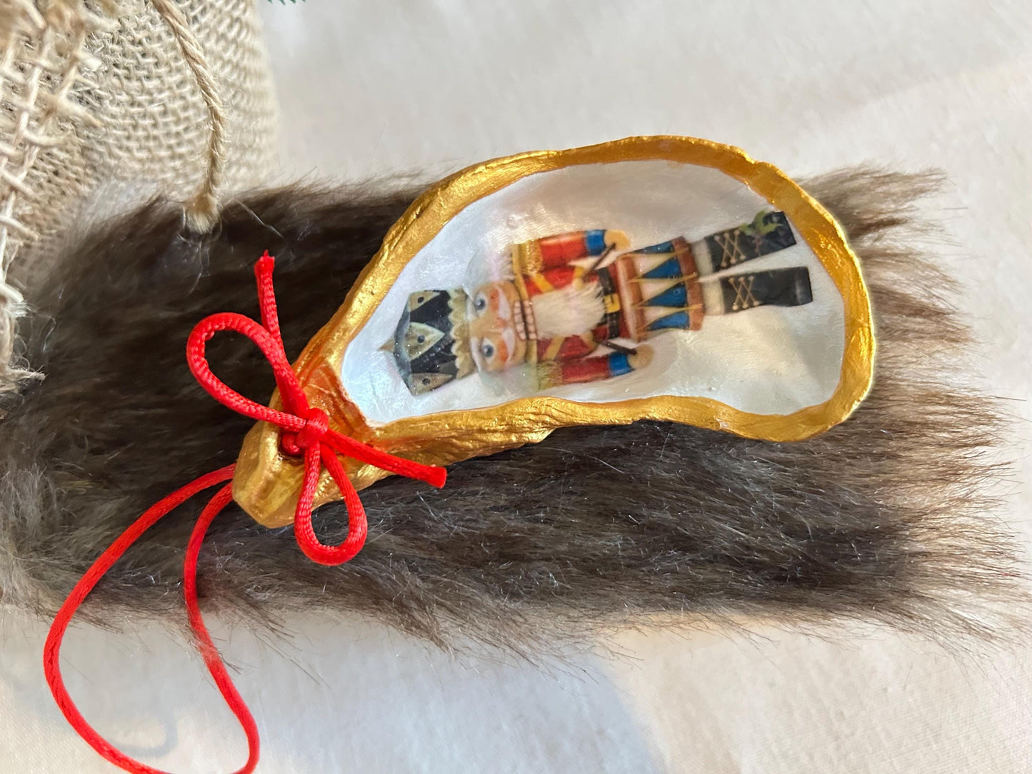 Nutcracker Oyster Shell Hanging Bauble. Festive Gold Christmas Soldier Tree Decoration.