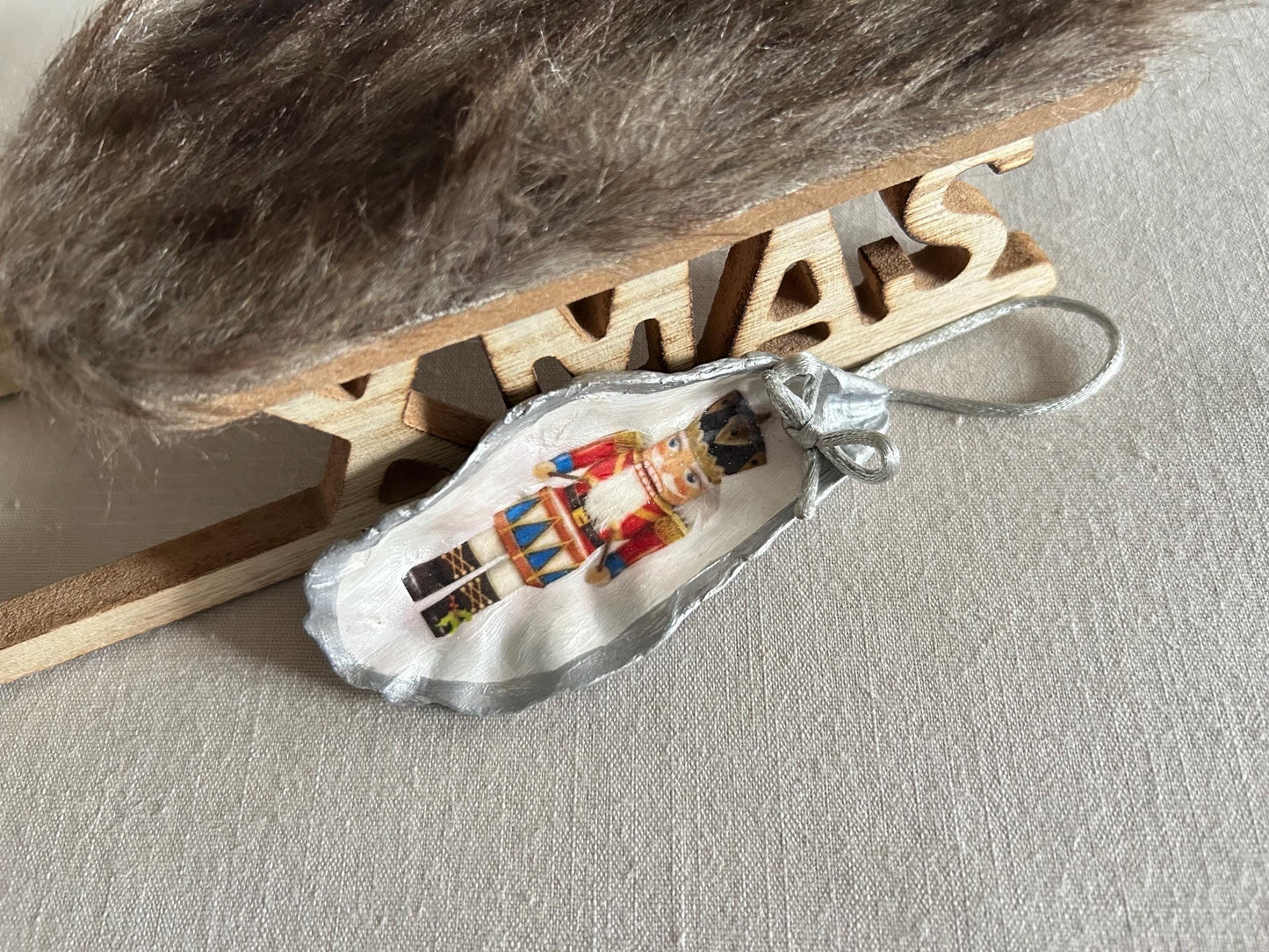 Silver Nutcracker Ornament. Coastal Holiday Home Decoration. Oyster Shell Bauble.