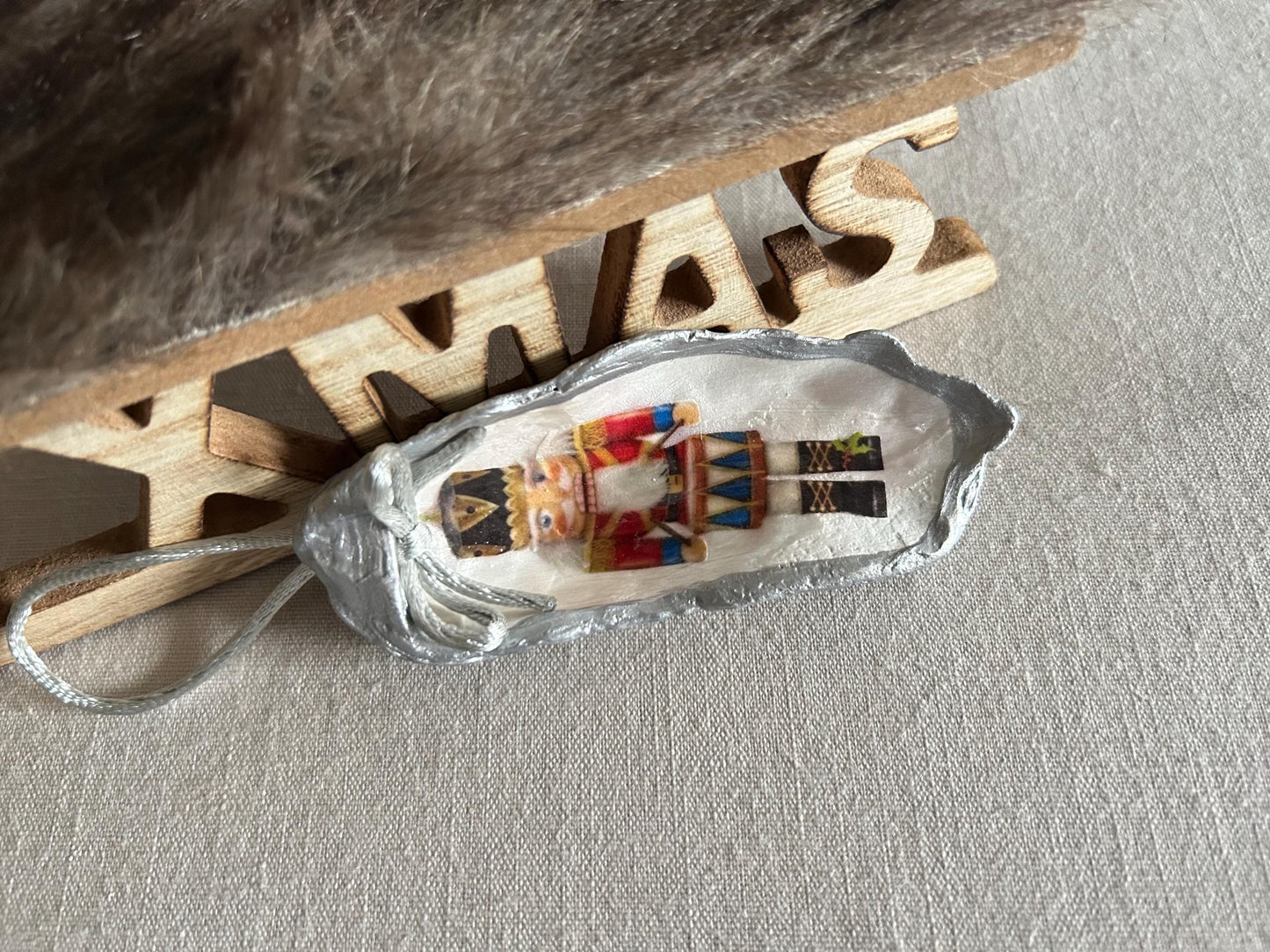 Silver Nutcracker Ornament. Coastal Holiday Home Decoration. Oyster Shell Bauble.