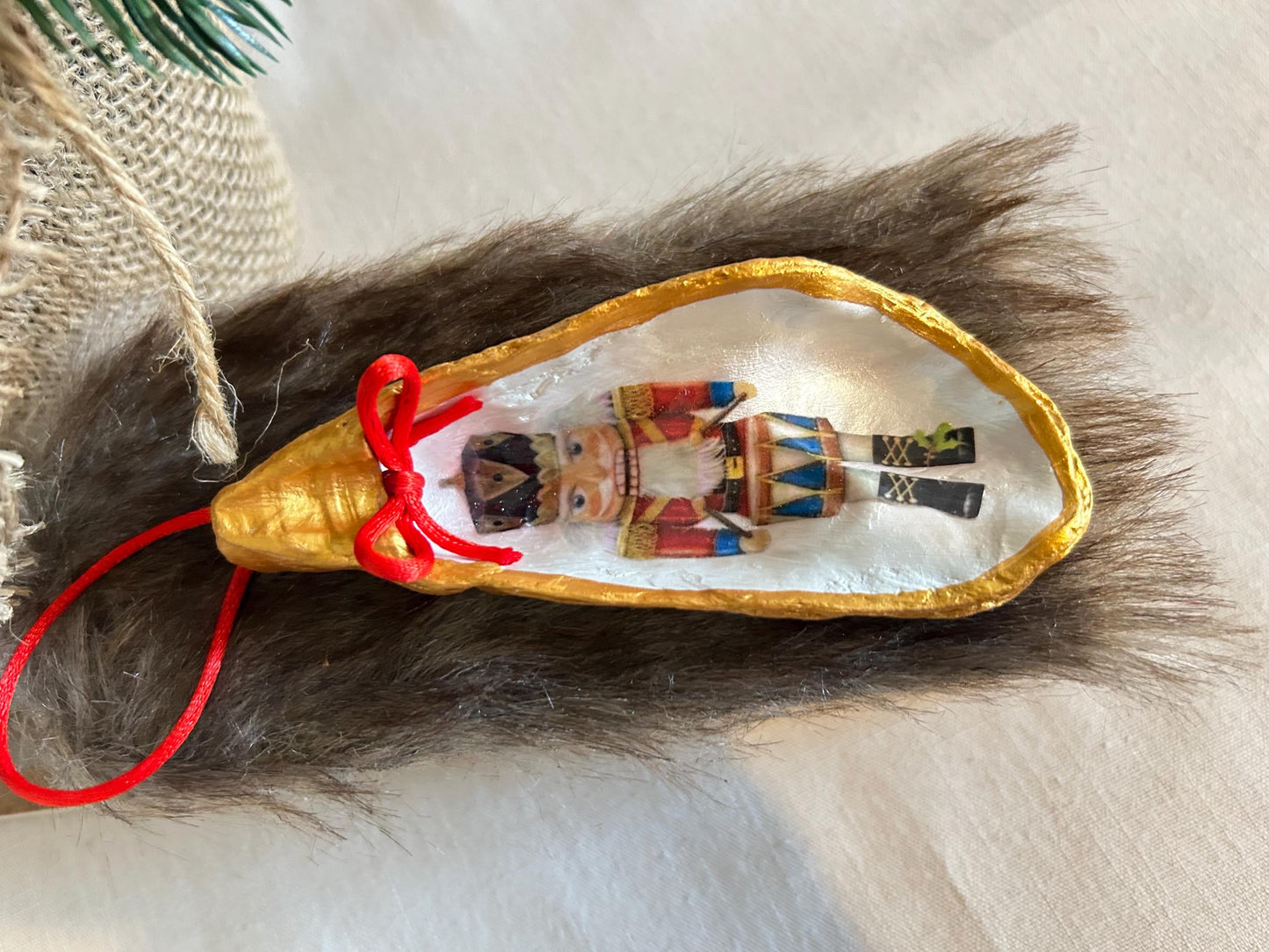 Nutcracker Oyster Shell Hanging Bauble. Festive Gold Christmas Soldier Tree Decoration.