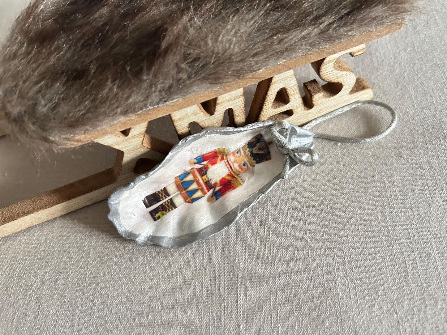 Silver Nutcracker Ornament. Coastal Holiday Home Decoration. Oyster Shell Bauble.