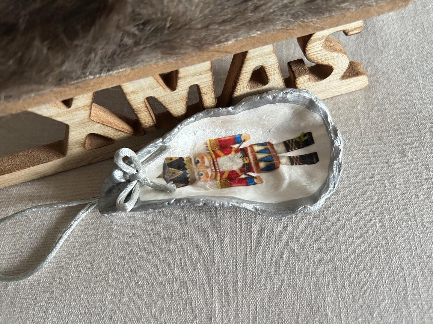 Silver Nutcracker Ornament. Coastal Holiday Home Decoration. Oyster Shell Bauble.