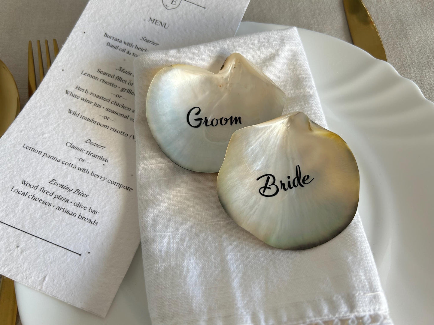 Elevate your table styling with these Black Lip Oyster Shell place cards, featuring a naturally iridescent black mother of pearl finish. Each shell is carefully personalised to create a striking yet timeless addition to your wedding or special event.