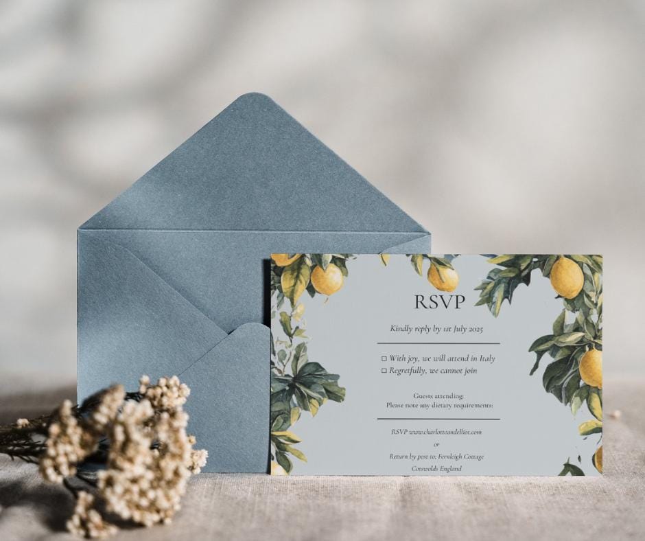 A pale blue RSVP card. The card has a lemon and leaf border design and the word "RSVP". The text includes a reply date and options to attend or decline, with a request for dietary requirements.