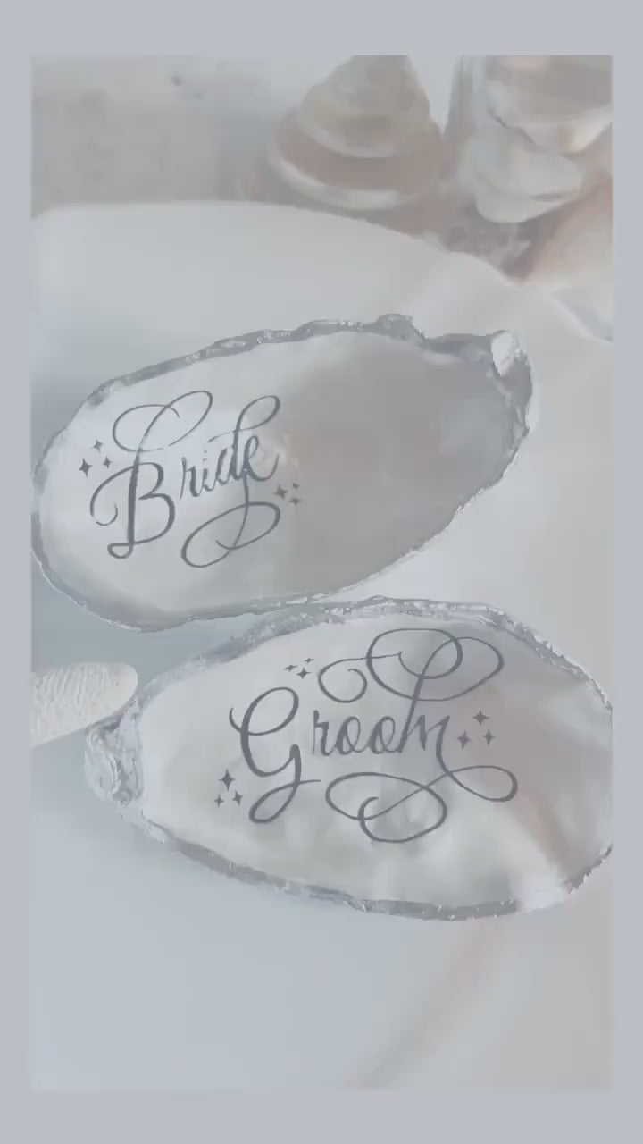 Oyster Shell Wedding Place Card and Favour. Personalised place names for your beach wedding decor. Silver coastal shell place settings.